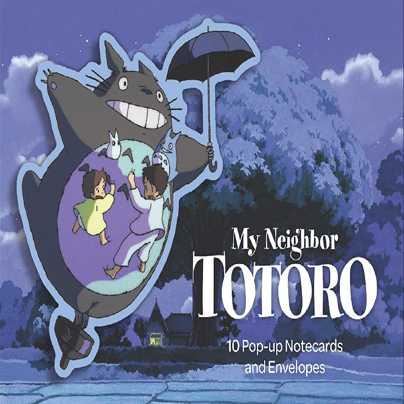 Studio Ghibli - My Neighbor Totoro: 10 Pop-Up Notecards and Envelopes painting of the the furry creature holding an umbrella flying in the air with two small children on his belly in the background a forest
